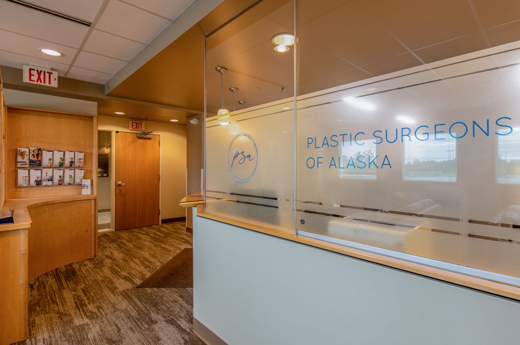 Plastic Surgeons of Alaska waiting room with logo